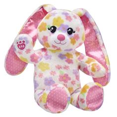 a pink and yellow stuffed animal with polka dots