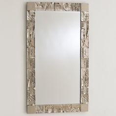 a mirror that is on the wall with an animal pattern in it's frame