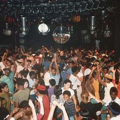 a large group of people dancing at a party