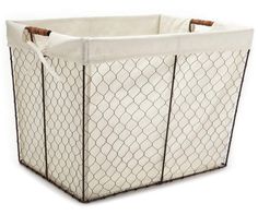 a white and brown wire basket with handles on the sides, sitting in front of a white background