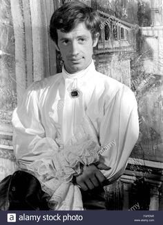 an old black and white photo of a young man in formal clothing