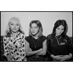 three women standing next to each other with their arms crossed