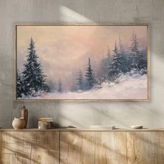 a painting hanging on the wall above a dresser in a room with wooden cabinets and drawers