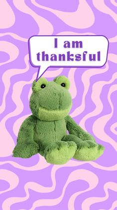 a green stuffed frog with a thought bubble saying i am thanks on it's face