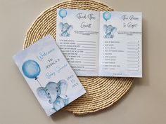 two baby shower games on a wicker place mat with an elephant design and blue balloons