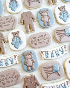 baby shower cookies with teddy bears and clothes on them are displayed for the guests to eat