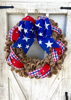 a patriotic wreath hanging on the front door