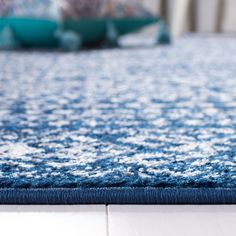 a blue and white rug on the floor