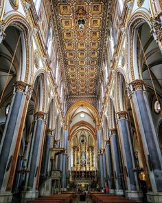 the interior of a cathedral with gold and blue columns