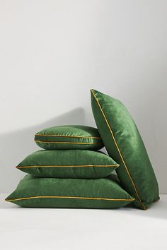 four green pillows stacked on top of each other