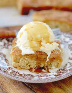 a piece of cake sitting on top of a plate with ice cream and sauce in it