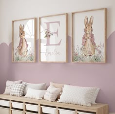 two framed pictures hang on the wall above a bench with pillows and baskets underneath it