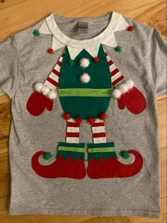 a gray shirt with an ugly green and red christmas sweater on it's chest