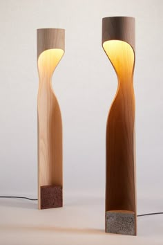 two wooden lamps sitting next to each other