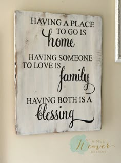 a wooden sign that says having a place to go is home and having someone to love is family having both is a blessing