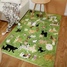 a green rug with dogs on it in a living room