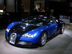 a blue and black bugatti is on display