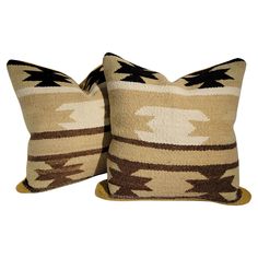 two brown and white pillows sitting next to each other