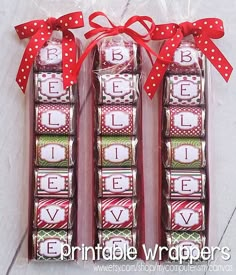 three packages of candy wrapped in red ribbon