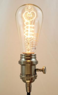 a light that is on top of a metal pole with a light bulb attached to it