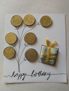 a birthday card with coins and a yellow ribbon tied around the top that says happy birthday