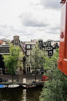 boats are parked on the water in front of buildings