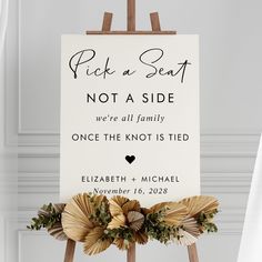 a wooden easer holding a sign that says pick a seat not a side, we're all family once the knot is tied