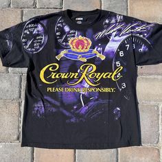 a black t - shirt with the words crown royal on it and a clock in the background