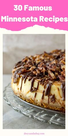 a cheesecake topped with chocolate and pecans on top of a glass cake plate