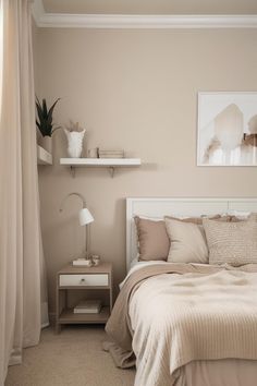 a bed sitting in a bedroom next to a window with drapes on the windowsill