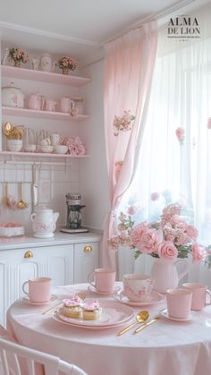 a dining room table with plates and cups on it, pink flowers in vases