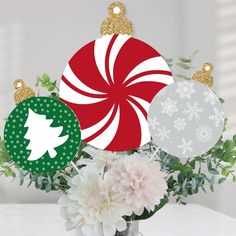 a vase filled with flowers and ornaments on top of a table