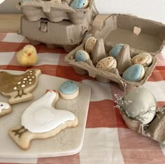 some decorated cookies and eggs on a table