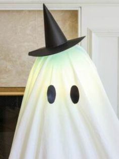 a white ghost with a black hat on it's head