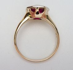 This is a very old and classic birthstone ring. This ring has a European cut round synthetic red stone in the center (most likely synthetic spinel but I don't have a way to test it) that measures 8.5 mm. The stone is set in a hexagonal white gold plate that is welded to a yellow gold shank. The ring is stamped 14K and weighs 3.6 grams. The ring is a size 6. This is such a classic item and it's in very good condition. The ring has been polished up a bit and looks almost new. Red Stone, Birthstone Ring, Solitaire Ring, Birthstone, Cocoa, Gold Plate, White Gold, Yellow Gold, Size 6