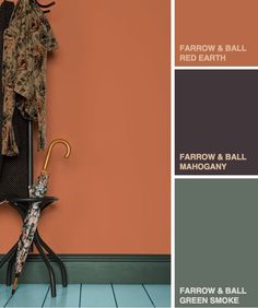 an orange and brown color scheme with clothes hanging on a coat rack next to a green and orange wall