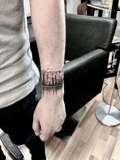 Wristband tattoo done by Jon Koon at Artistic studio hair and tattoo Singapore Nature Tattoos Forearm, Small Wrist Tattoos For Men, Tattoos For Men Unique, Forest Tattoo Sleeve, Natur Tattoo Arm, Wrist Band Tattoo, 2024 Minimalist, Band Tattoos For Men, Tattoos 2024