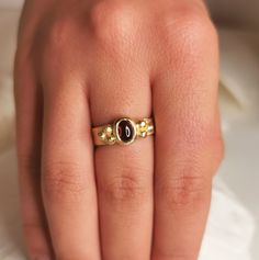 A beautiful organic 18k solid yellow gold ring with hammered surface, about 4.5- 5mm wide and a deep red garnet center stone.  With 3 small golden balls on either side.  This ring is made with sacred geometry and divine numbers.  A very special and unique ring for protection  18k yellow gold  4.5-5mm wide  Weight: About 6g Thickness: about 1mm + a garnet stone - 7x5 Please send a message for a custom order - can be made with any center stone and in any color / karat of gold.  ◈ ENGRAVING is optional for $7 per letter/number/character. Please pay using the engraving order form at this link: https://www.etsy.com/il-en/listing/1067854382/personalisation-engravings?ref=shop_home_active_1&frs=1&crt=1 Please note that engraved jewellery cannot be exchanged or returned ◈ SHIPPING is insured expre Gold Garnet Rings With Cabochon, Yellow Gold Garnet Signet Ring With Gemstone, Elegant Hand Forged Yellow Gold Ruby Ring, Gold Garnet Signet Ring For Anniversary, Divine Numbers, Organic Engagement Rings, Hammered Gold Ring, Ancient Jewels, Antique Style Rings