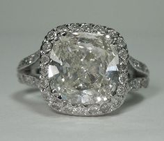 an oval cut diamond surrounded by pave diamonds