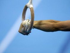 a close up of a person's hand holding an object in the air