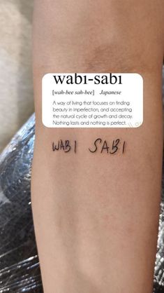 a person with a tattoo on their arm that says wabi - sabii