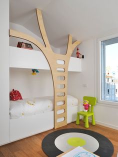 a room with bunk beds and a tree shaped bed in the corner, on instagram