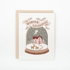 a christmas card with a snow globe and houses in the background that says winter is here