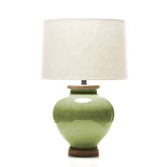 a green ceramic table lamp with a white shade