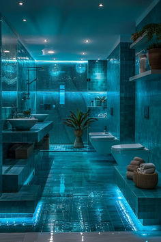 a large bathroom with blue lights on the walls and tiled floors, along with two sinks