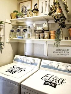 a washer and dryer sitting next to each other in a room with shelves