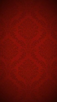 a red wallpaper with an ornate pattern on it's side and the bottom corner