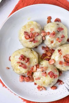 bacon and cheese biscuits on a plate with a fork next to it, ready to be eaten