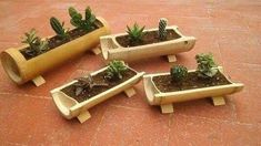 four wooden planters with succulents in them sitting on the tile floor