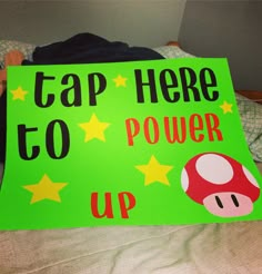 a green sign that says cap here to power up with stars and a mushroom on it